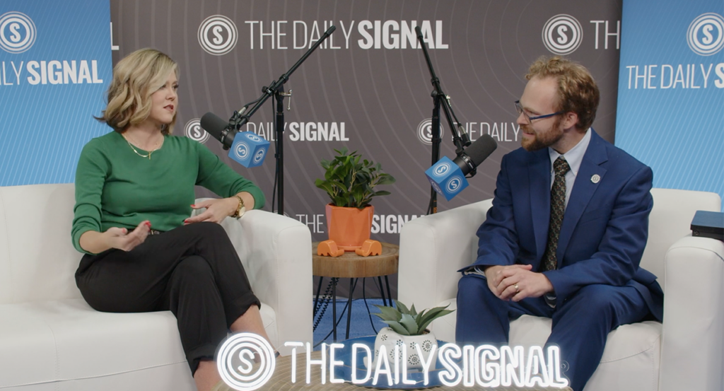 Daily Wire reporter Meg Basham with The Daily Signal's Tyler O'Neil sitting for an interview