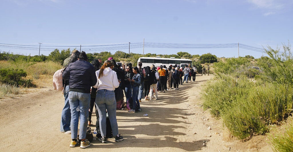 Illegal aliens wait to board a Border Patrol bus Wednesday after crossing the U.S.-Mexico border into Jacumba Hot Springs, California.