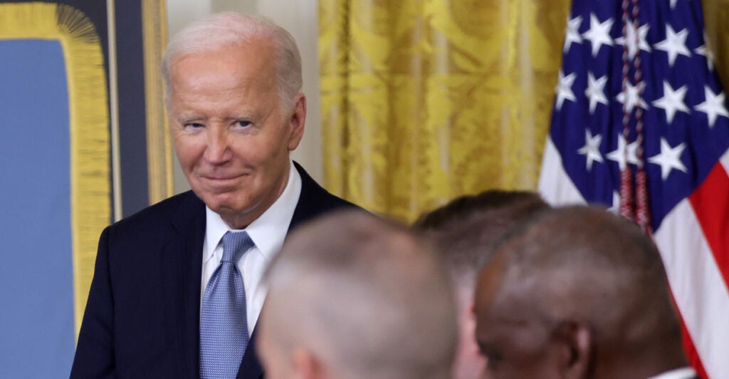 President Joe Biden smirking.