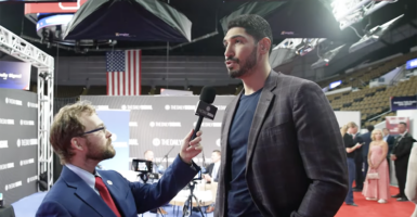 Tyler O'Neil in a blue suit and Enes Kanter Freedom in a checkered gray suit