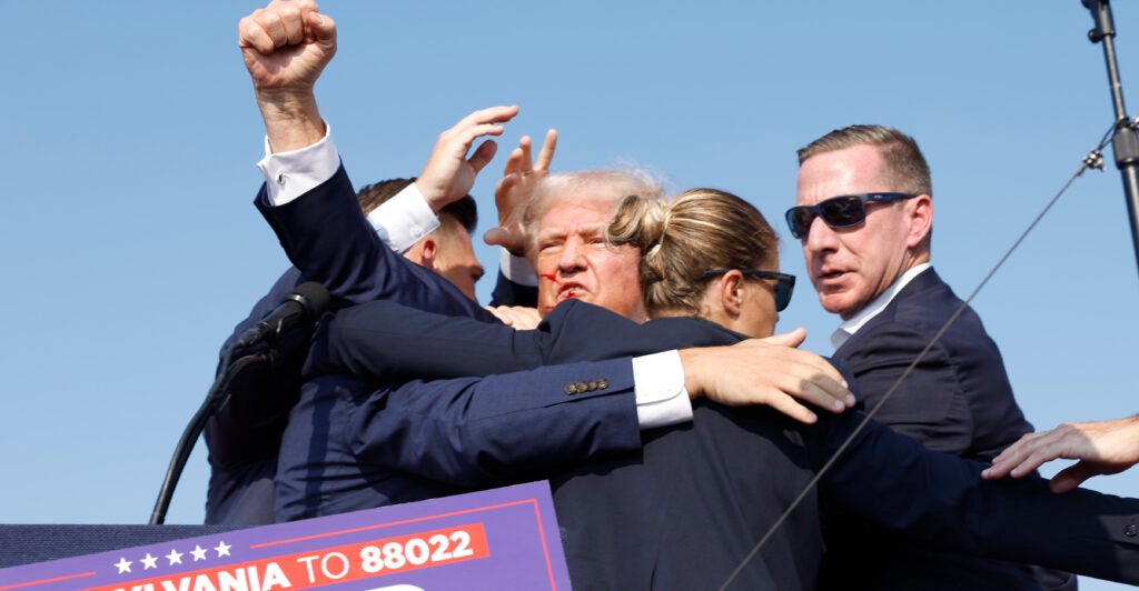 Republican presidential candidate former President Donald Trump is rushed offstage after being shot during a rally on July 13, 2024 in Butler, Pennsylvania. (Photo by Anna Moneymaker/Getty Images)