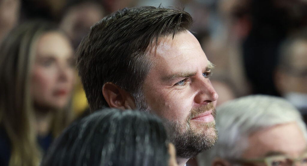 J.D. Vance smiles while looking upward