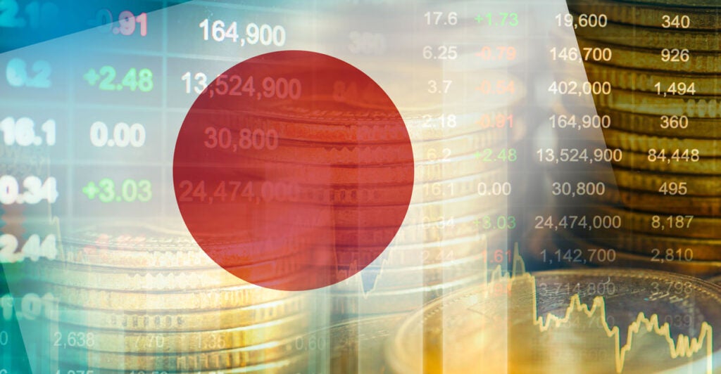 The Japanese flag with a backdrop of financial charts.