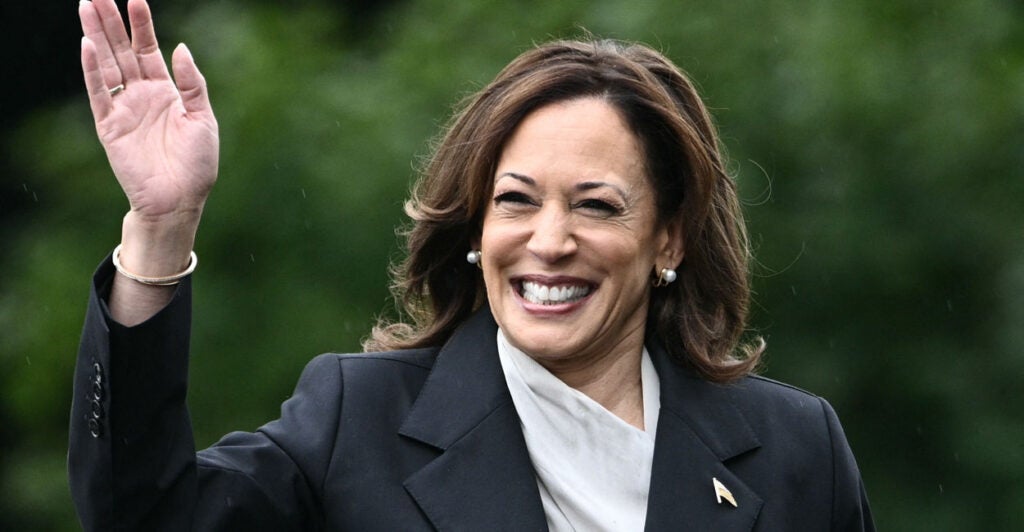 Kamala Harris smiling and waving.