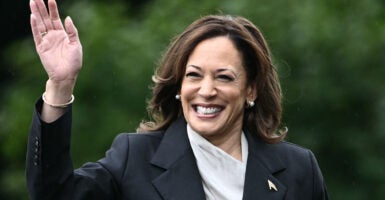 Kamala Harris smiling and waving.