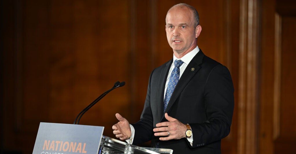 Heritage Foundation President Kevin Roberts giving a speech at a podium.