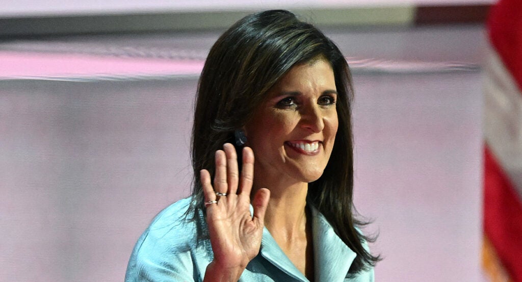 Nikki Haley waves with a grin on her face