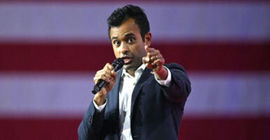 Vivek Ramaswamy speaking into a microphone and pointing.