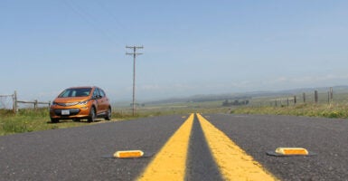 electric vehicle stranded by the side of a country road in the middle of nowhere