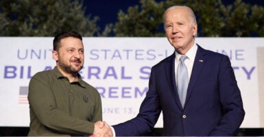 Ukrainian President Volodymyr Zelenskyy and President Joe Biden Shake hands on stage