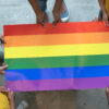 Students hold an LGBTQ flag.