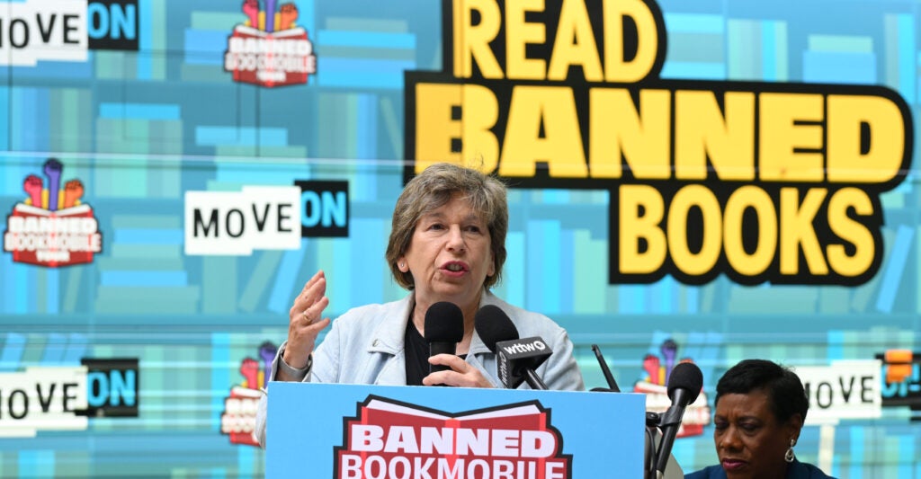 Randi Weingarten speaks in front of a background that says "Read Banned Books."