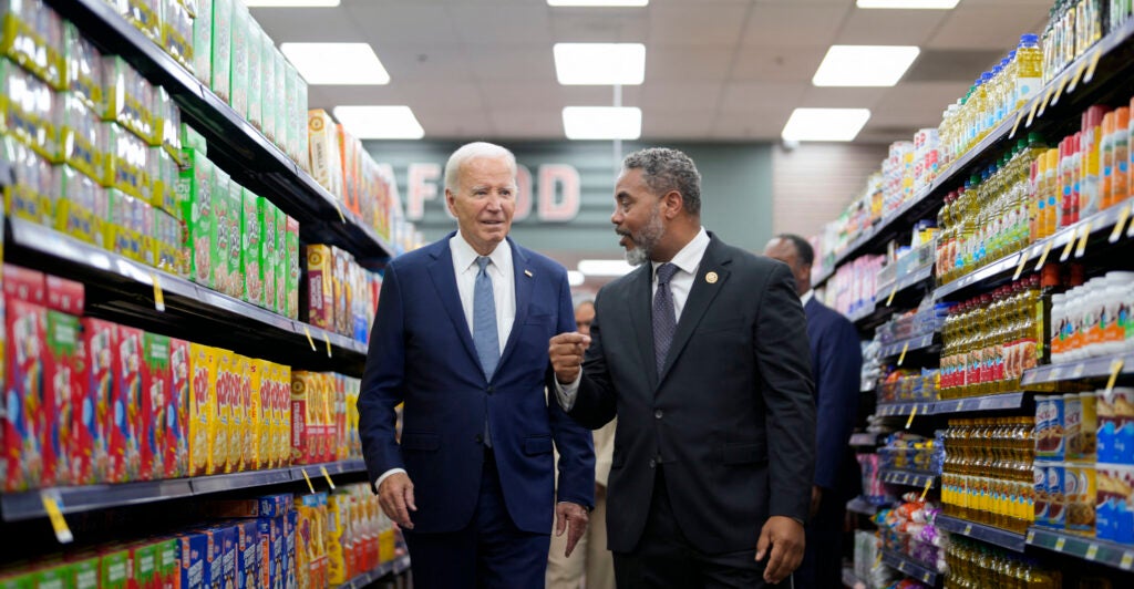 President Joe Biden walks with U.S. Representative Steven Horsford, D-Nevada, down a grocery store aisle.