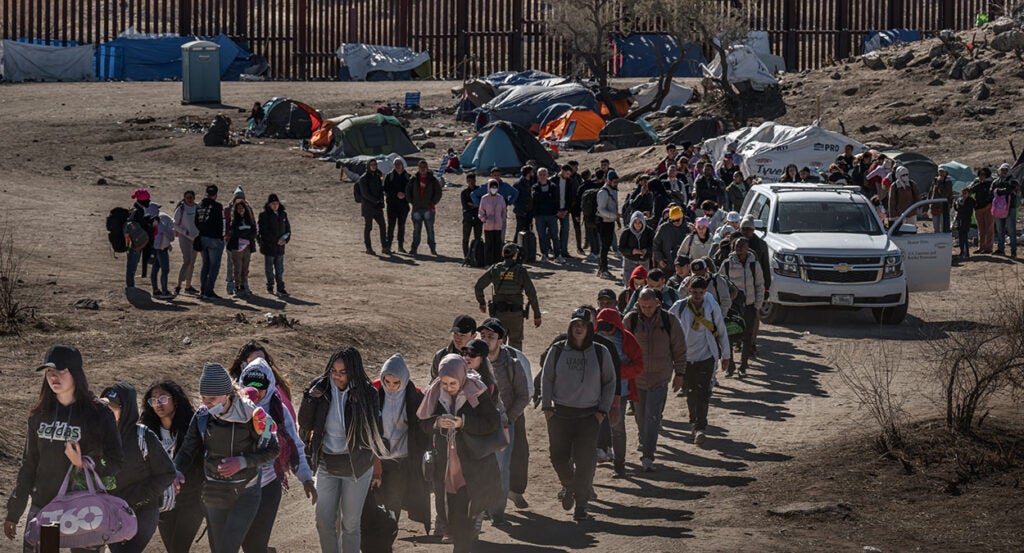 Illegal aliens walking after crossing the border