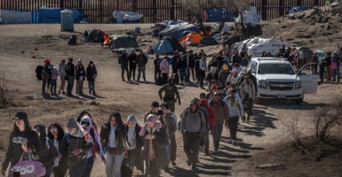 Illegal aliens walking after crossing the border