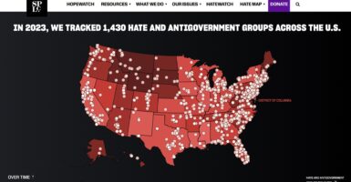 A red and black map of the U.S. with "hate map" dots