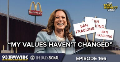 Kamala Harris in front of McDonalds with signs showing her previous positions