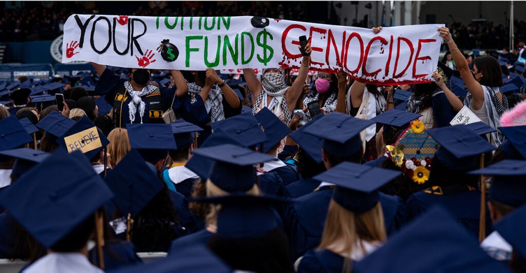 Students hold up Pro-Palestine banners in protest at George Washington University's graduation ceremony