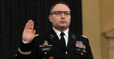 Alexander Vindman in his military uniform holds up his right hand to testify