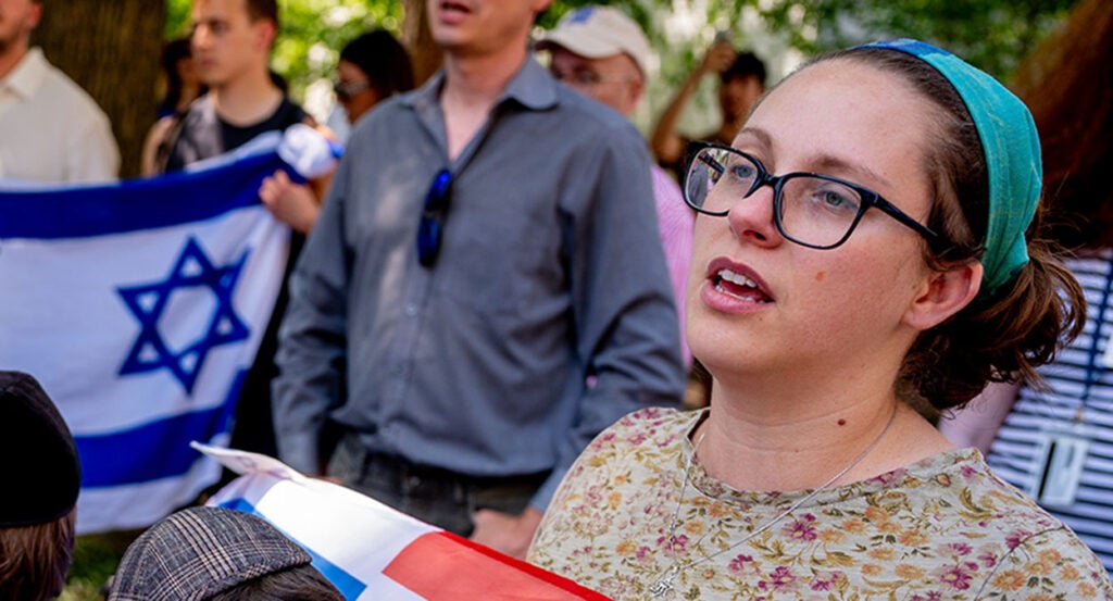 Bethany Mandel holds an American and Israel flag