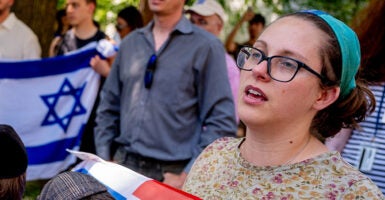 Bethany Mandel holds an American and Israel flag