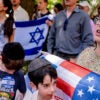 Bethany Mandel holds an American and Israel flag