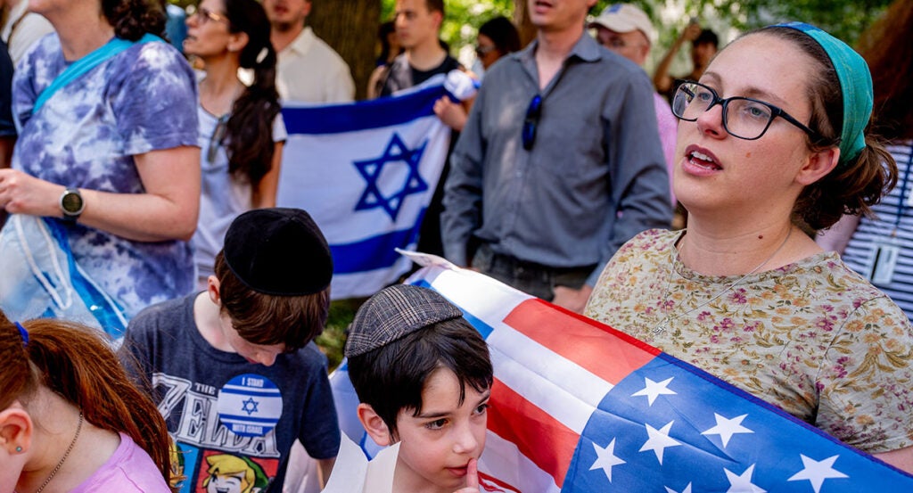 Bethany Mandel holds an American and Israel flag