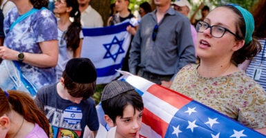 Bethany Mandel holds an American and Israel flag