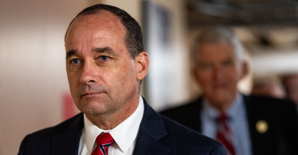 Bob Good in navy suit and red tie.