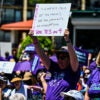 Pro-abortion protesters hold signs.