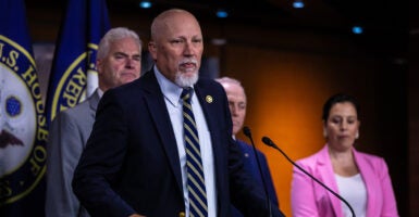 Chip Roy speaks into a microphone