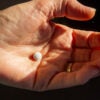 Woman holds pill