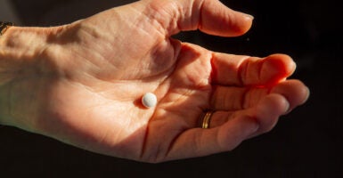 Woman holds pill