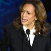 Kamala Harris on stage looking upset talking to Donald Trump offscreen