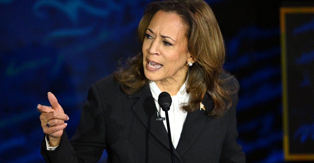 Kamala Harris on stage looking upset talking to Donald Trump offscreen