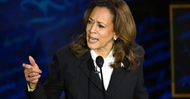 Kamala Harris on stage looking upset talking to Donald Trump offscreen