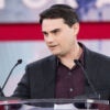 Ben Shapiro gestures in a suit at CPAC