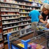 Patrons in a grocery store aisle with full shelves