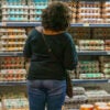 A shopper is seen at Whole Foods Market Staring at a wall full of egg cartons