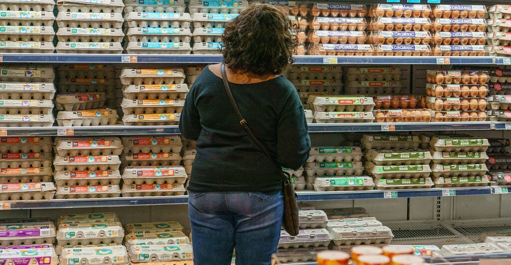 A shopper is seen at Whole Foods Market Staring at a wall full of egg cartons