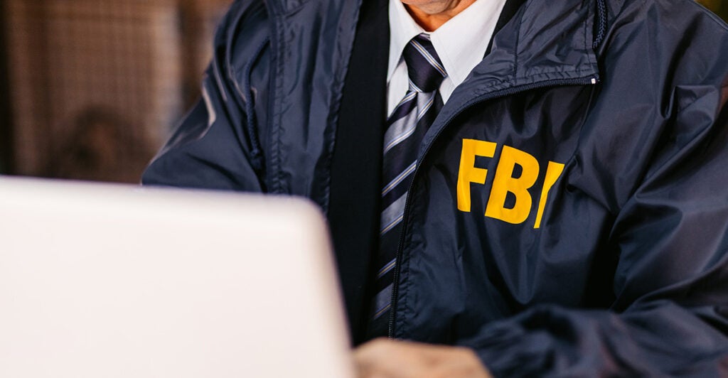 Handsome mature FBI agent using laptop in the office late at night. (Photo: https://www.gettyimages.com/search/photographer?(Photo: urbazon/ Getty Images)