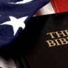 The Bible resting on an American Flag. (kledge/Getty Images)