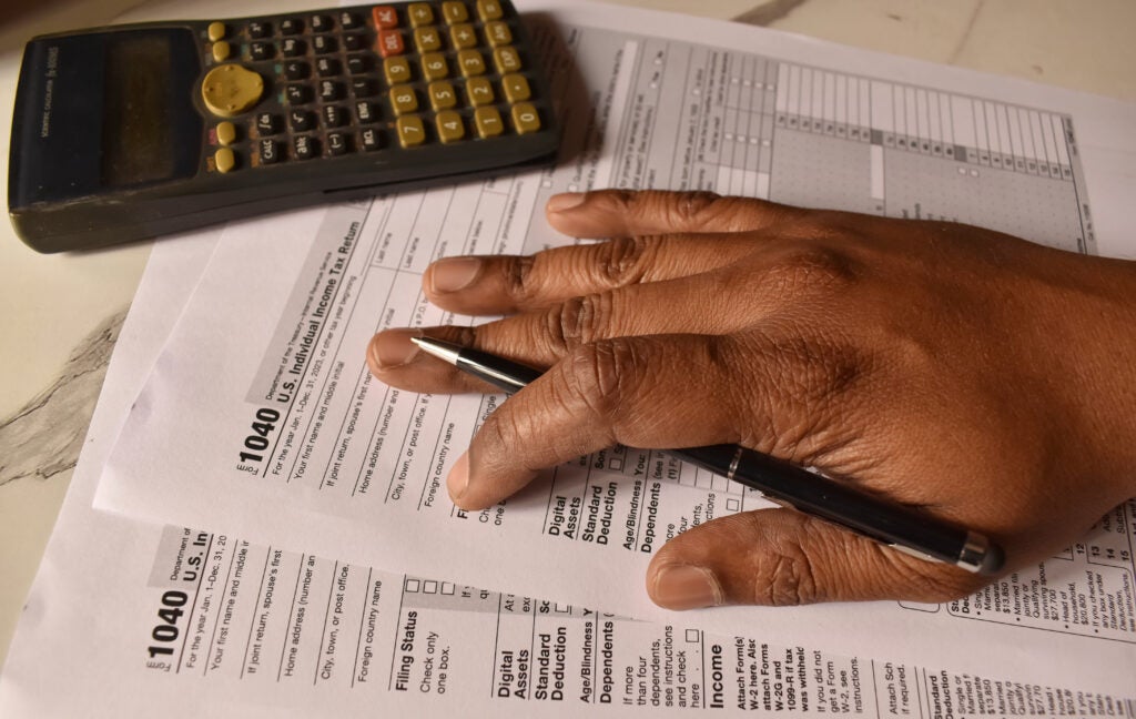 A closeup picture of a 1040 forms on a table with a black pen on it. US tax form. (Chinmayi Shroff/ Getty Images)