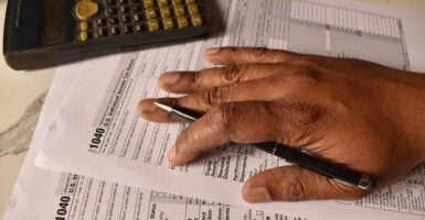 A closeup picture of a 1040 forms on a table with a black pen on it. US tax form. (Chinmayi Shroff/ Getty Images)