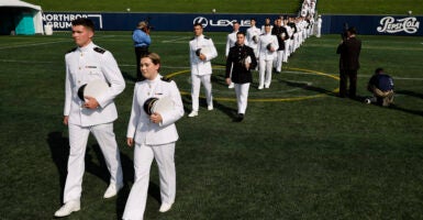 U.S. Naval Academy midshipmen walk in pairs into the Navy-Marine Corps Memorial Stadium for their graduation ceremony at the academy on May 24, 2024 in Annapolis, Maryland. (Chip Somodevilla/Getty Images)