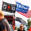 A veterans flag and a flag supporting U.S. Republican Presidential nominee former President Donald Trump fly outside a rally for Trump at the Brick Breeden Fieldhouse at Montana State University on August 9 in Bozeman, Montana. (Michael Ciaglo/Getty Images)