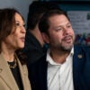 Kamala Harris in a tan sport coat stands by Ruben Gallego in a blue suit