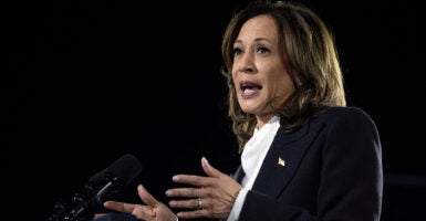 Kamala Harris in a black suit gestures