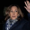 Kamala Harris with a paisley scarf waves in the night