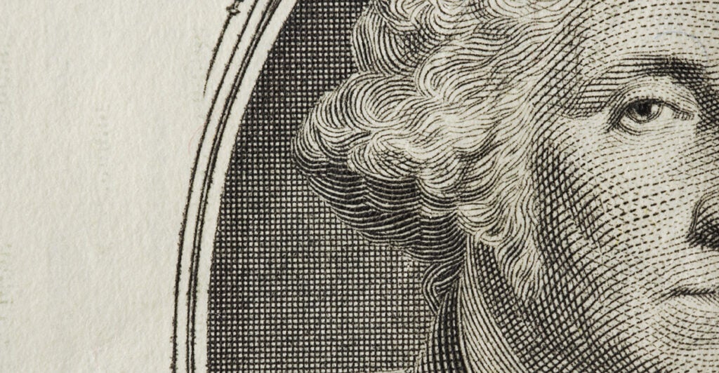 A closeup of a George Washington on a dollar bill